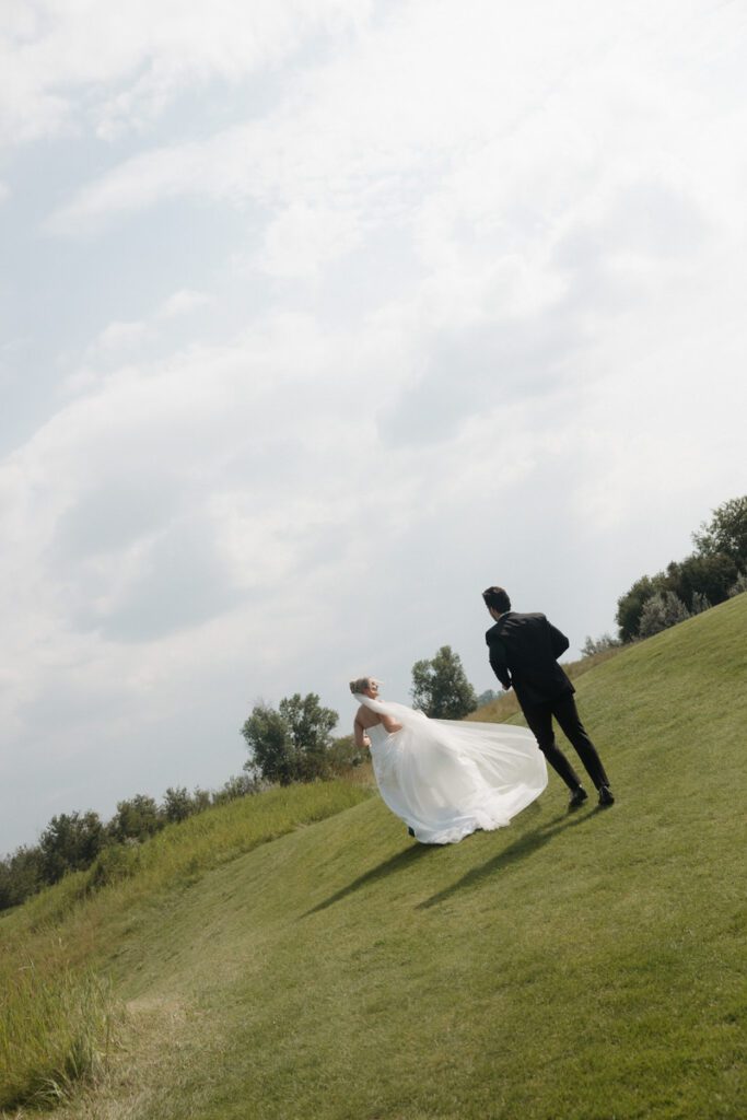 bride and groom running during their moon lake wedding photography