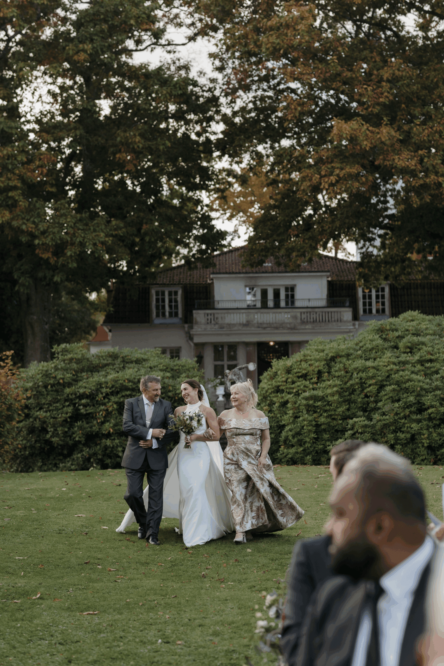 Outdoor wedding ceremony surrounded by family and friends.
