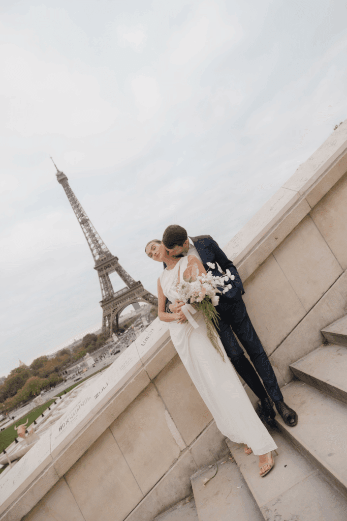 Modern Paris elopement featuring a sculptural silk gown and soft overcast light.