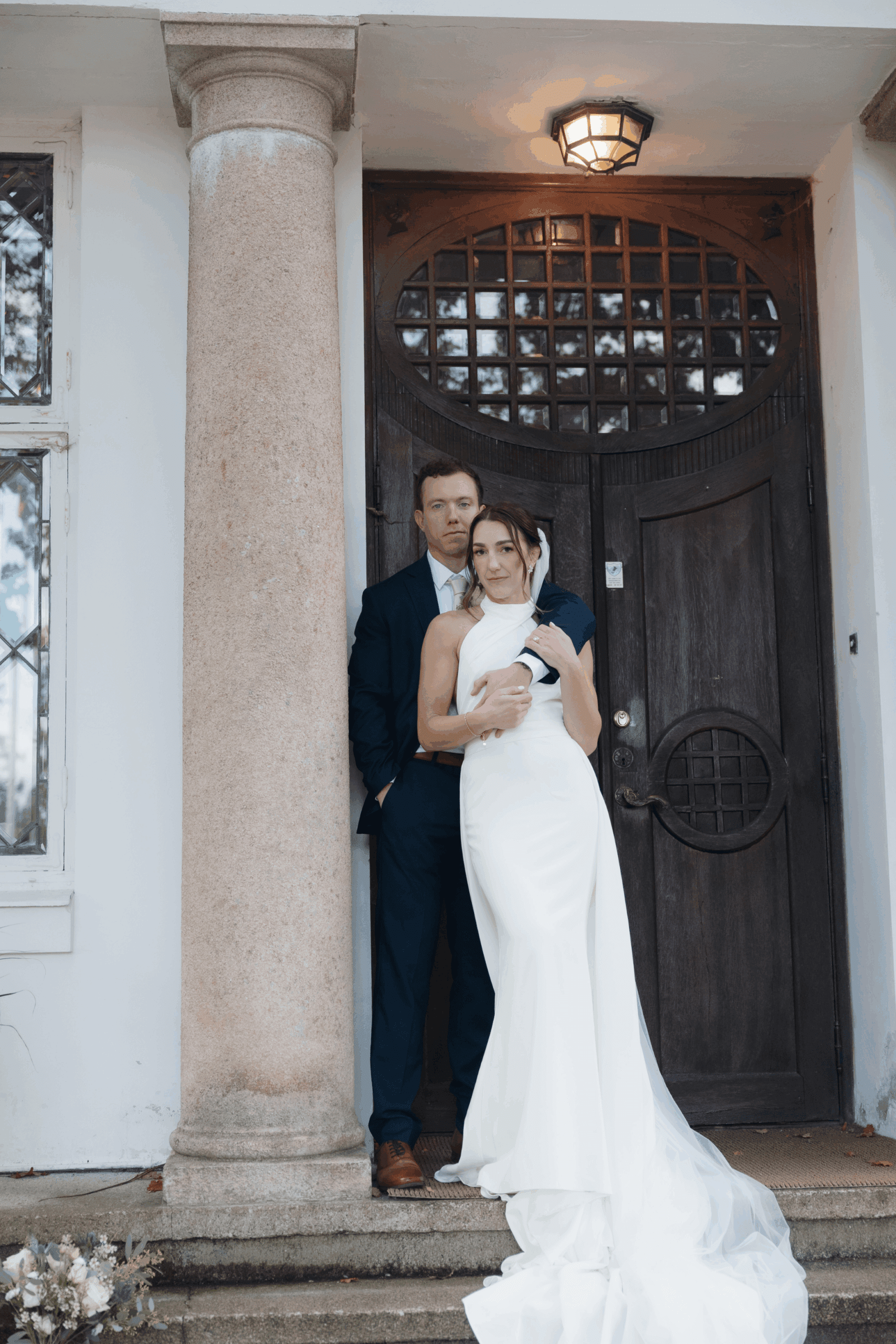 Couple embracing outdoors after their ceremony.