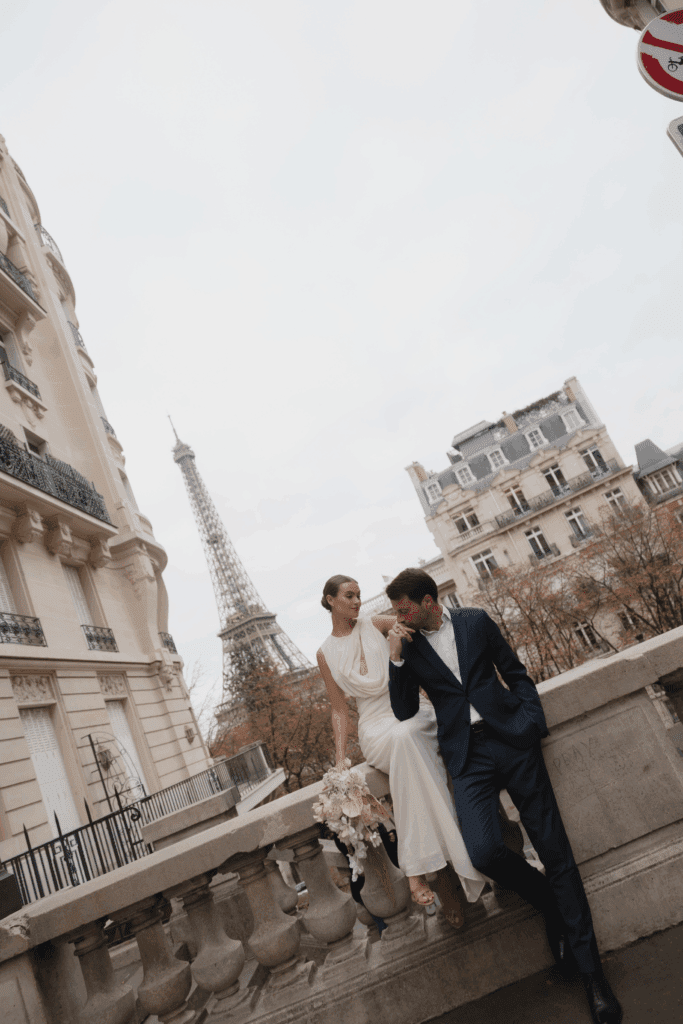 Bride and groom during an intimate Paris elopement with the Eiffel Tower in the distance.