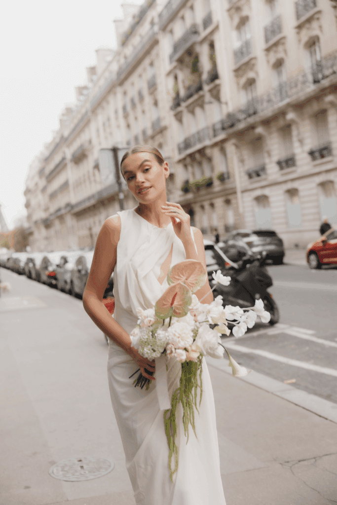 Modern Paris elopement featuring a sculptural silk gown and soft overcast light.