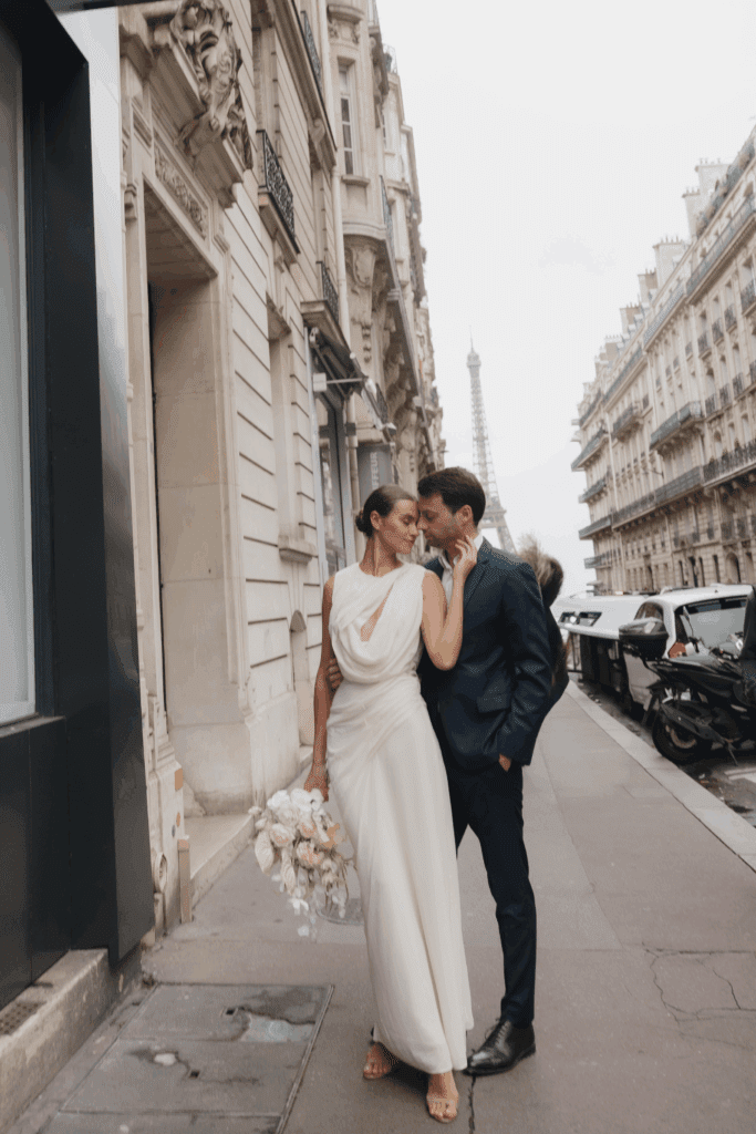 Modern Paris elopement featuring a sculptural silk gown and soft overcast light.