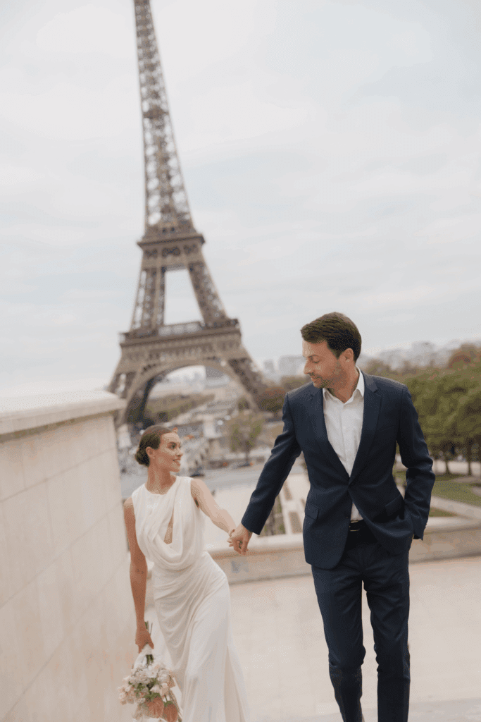 Bride and groom during an intimate Paris elopement with the Eiffel Tower in the distance.